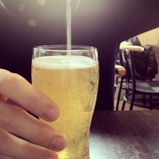 light yellow beer being poured in a glass